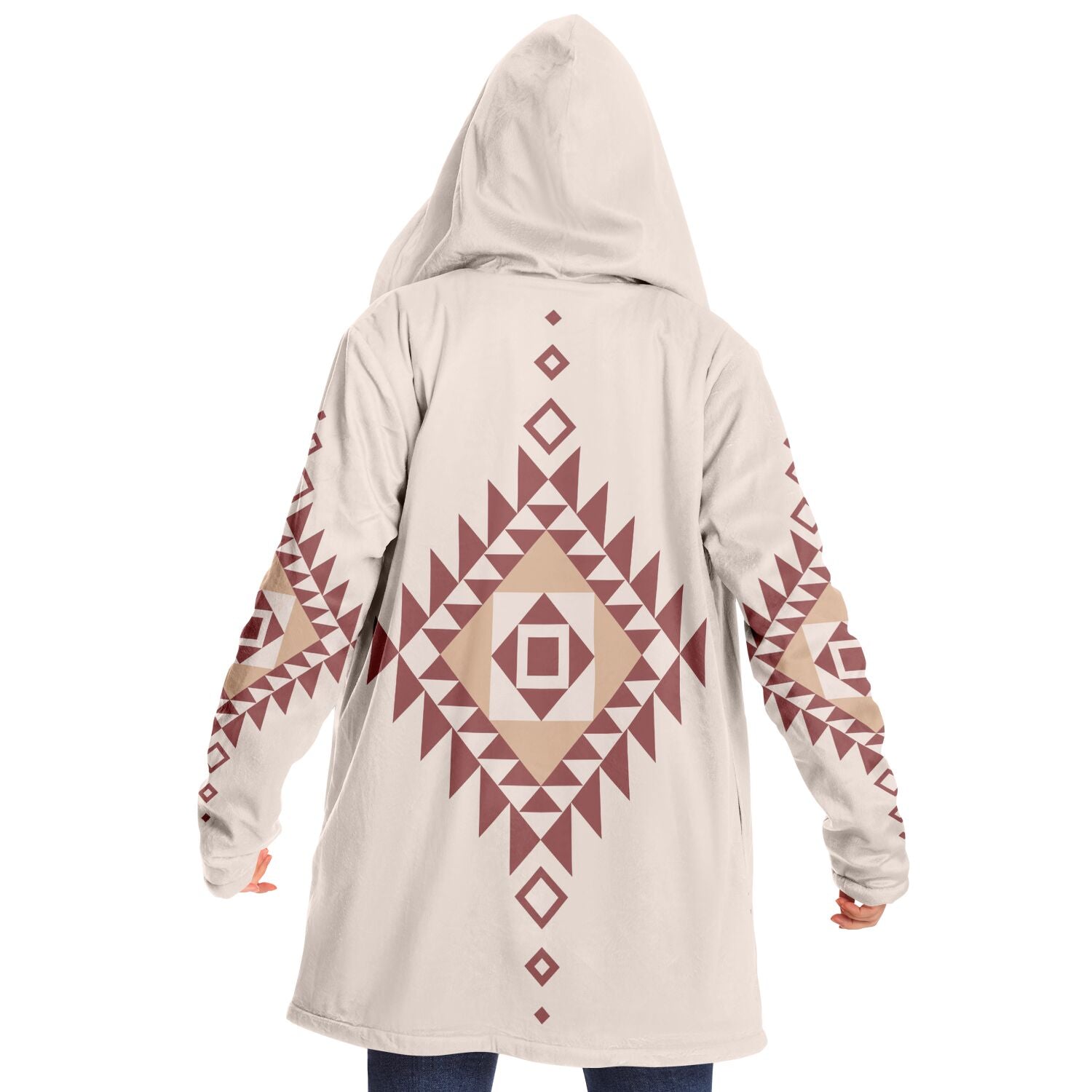 Woman wearing a cozy, hooded, beige microfleece cloak with a pink and tan Southwestern diamond shaped design on the back and elbows.