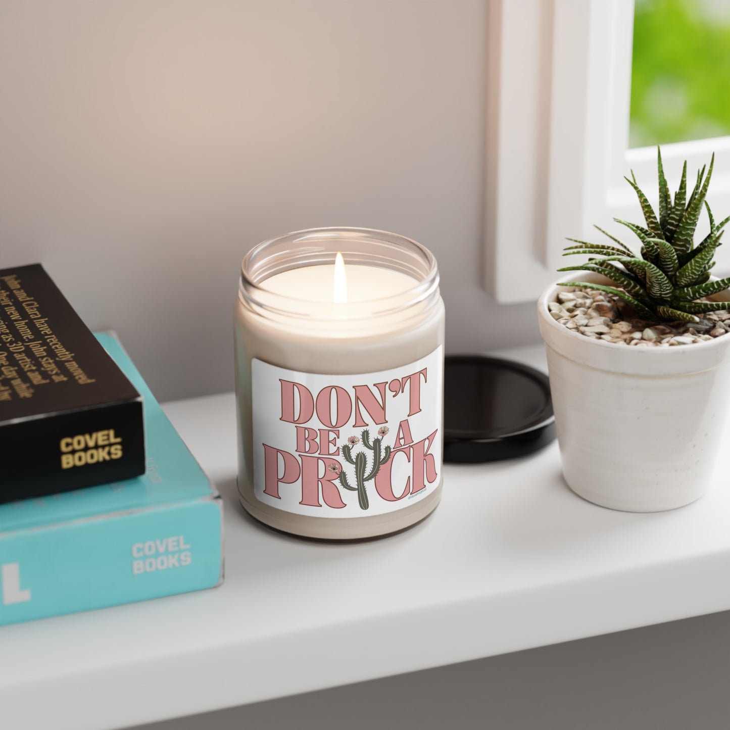 Eco friendly, 9oz soy wax candle with cotton wick and "Don't Be A Prick" design.