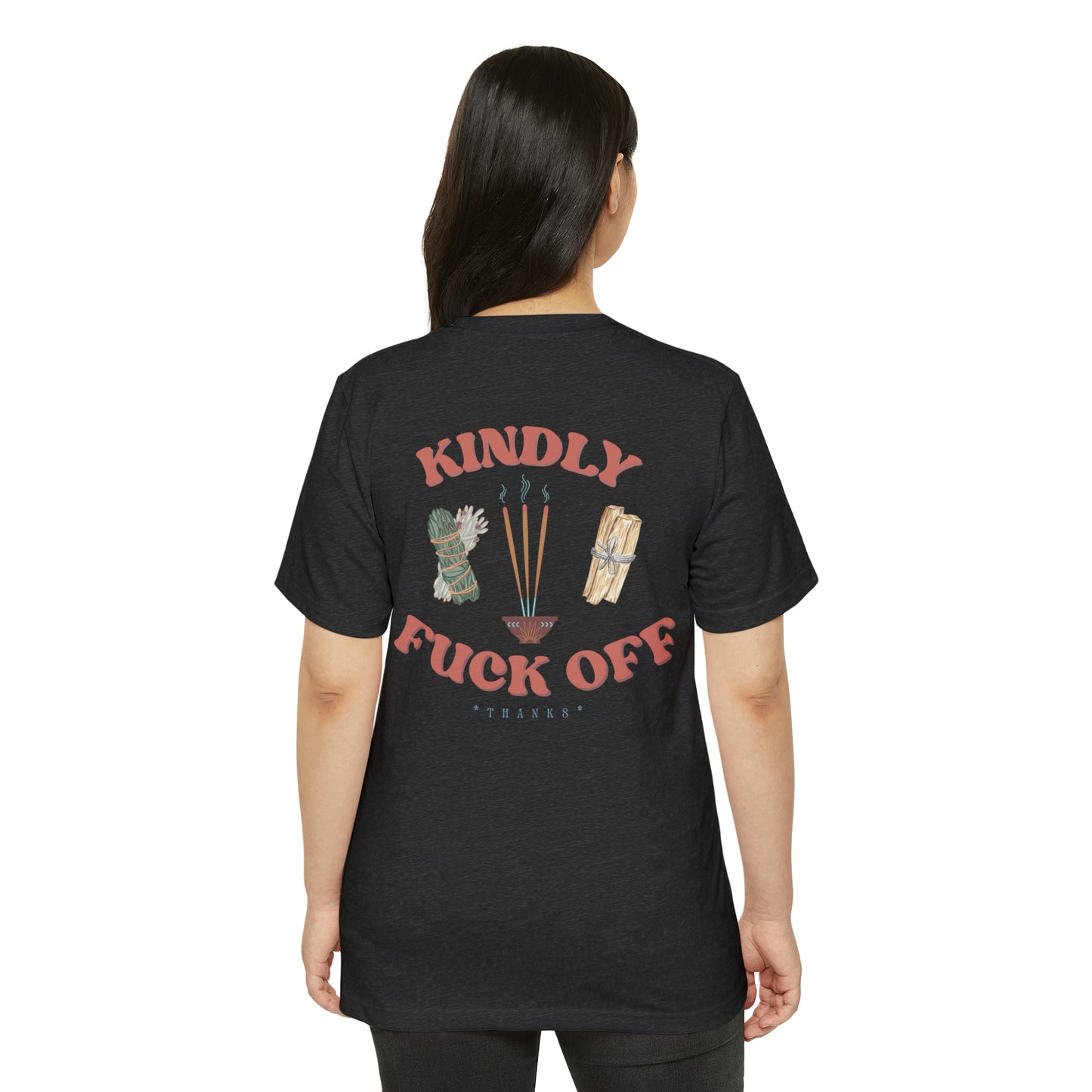 Woman wearing a dark grey recycled, organic, short sleeved t-shirt that says Kindly Fuck Off with graphics of sage, incense, and palo santo on the back.