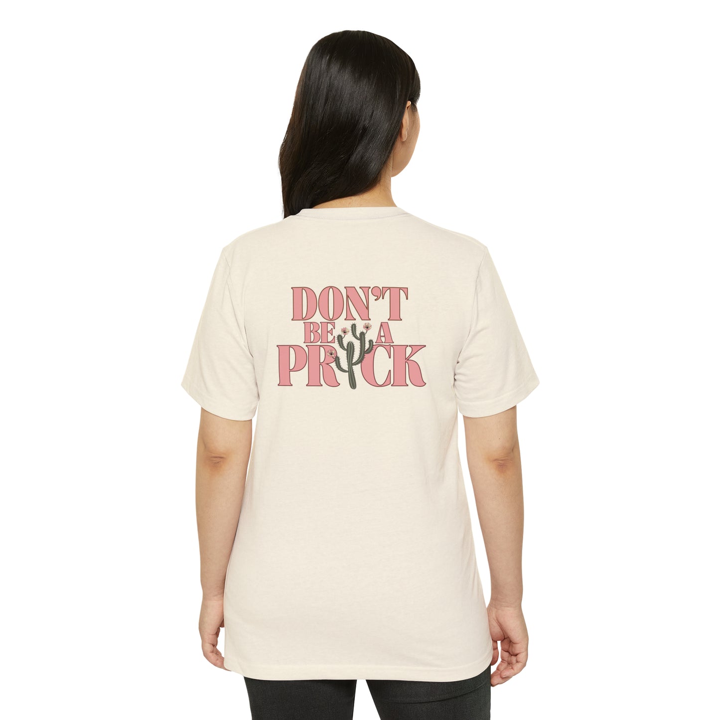 Woman wearing a natural beige recycled, organic, short sleeved t-shirt that says Don't Be A Prick on the back.