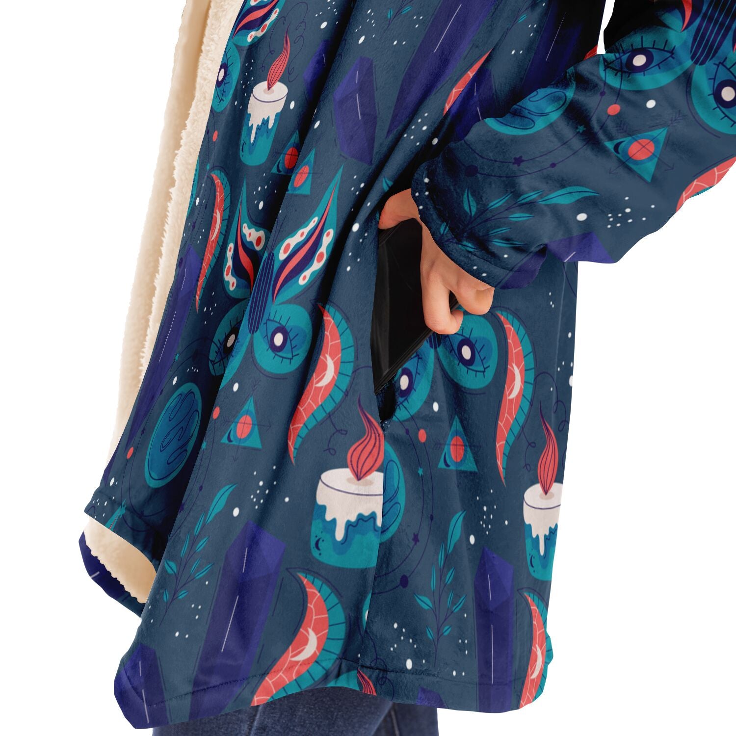 Woman putting a cell phone in the deep pocket of a blue microfleece hoodie with a colorful butterfly and candle design. 