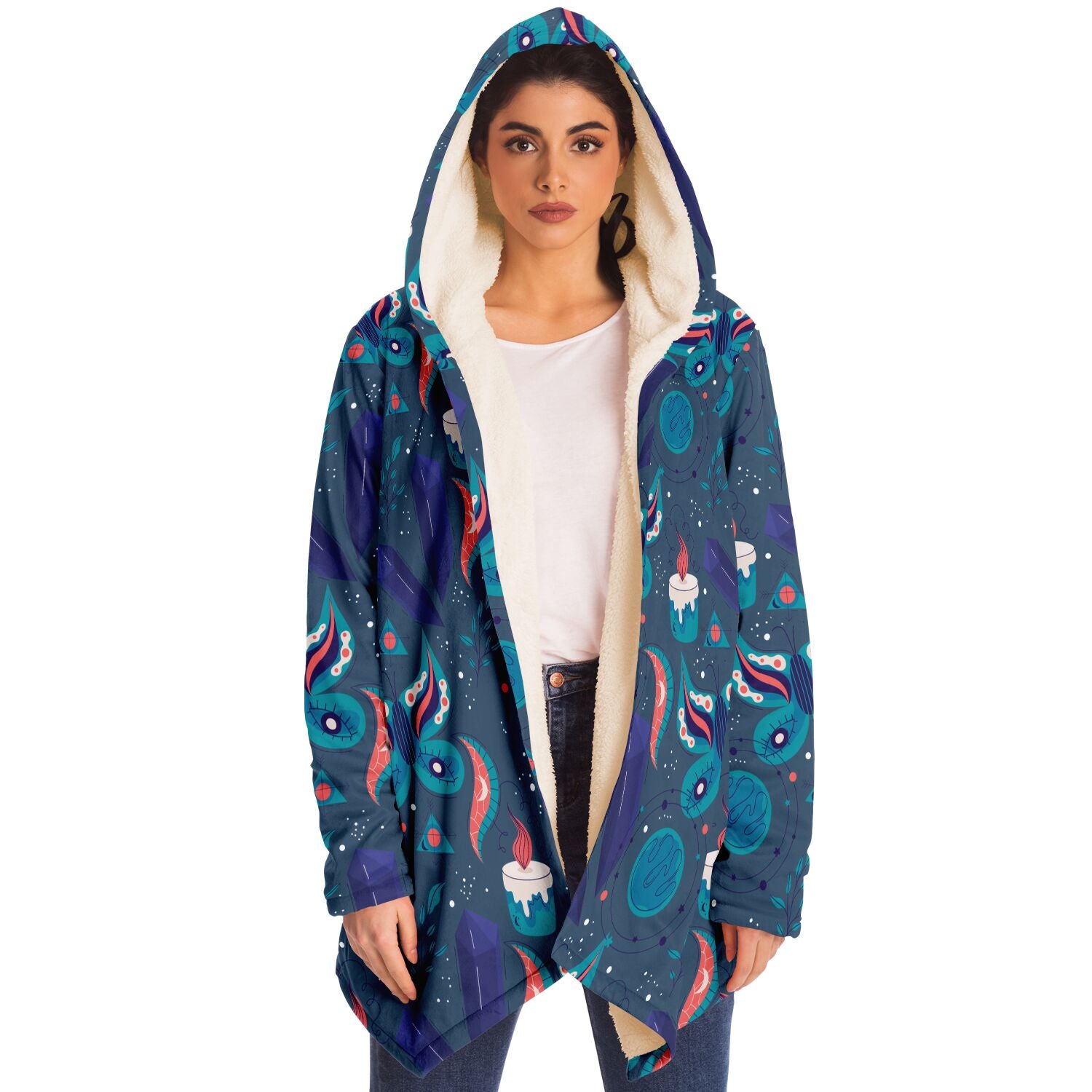 Woman wearing a cozy, hooded, blue microfleece cloak with a colorful butterfly and candle design