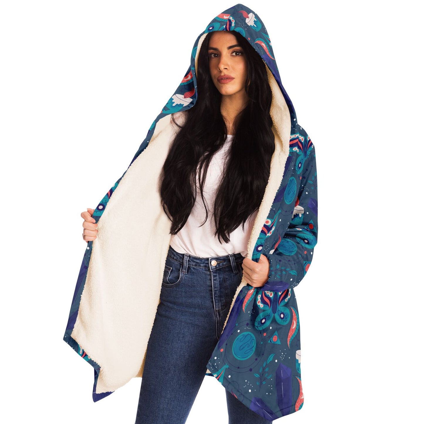 Woman wearing a cozy, hooded, blue microfleece cloak with a colorful butterfly and candle design