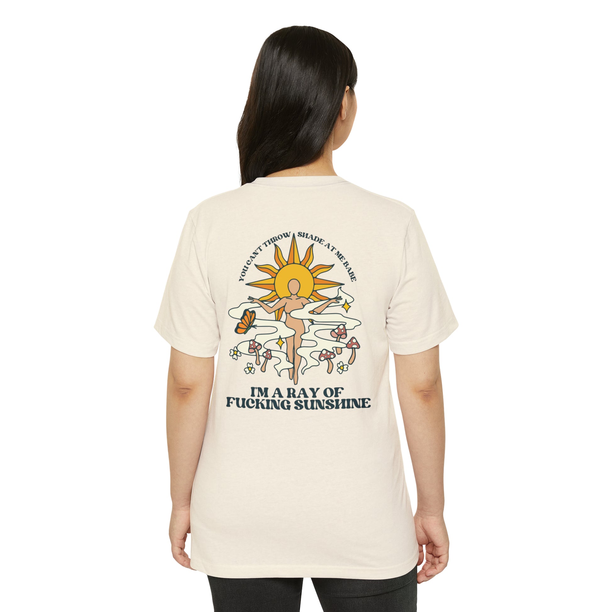 Woman wearing a natural beige recycled, organic, short sleeved t-shirt that says You Can't Throw Shade at Me Babe, I'm a Ray of Fucking Sunshine on the back.