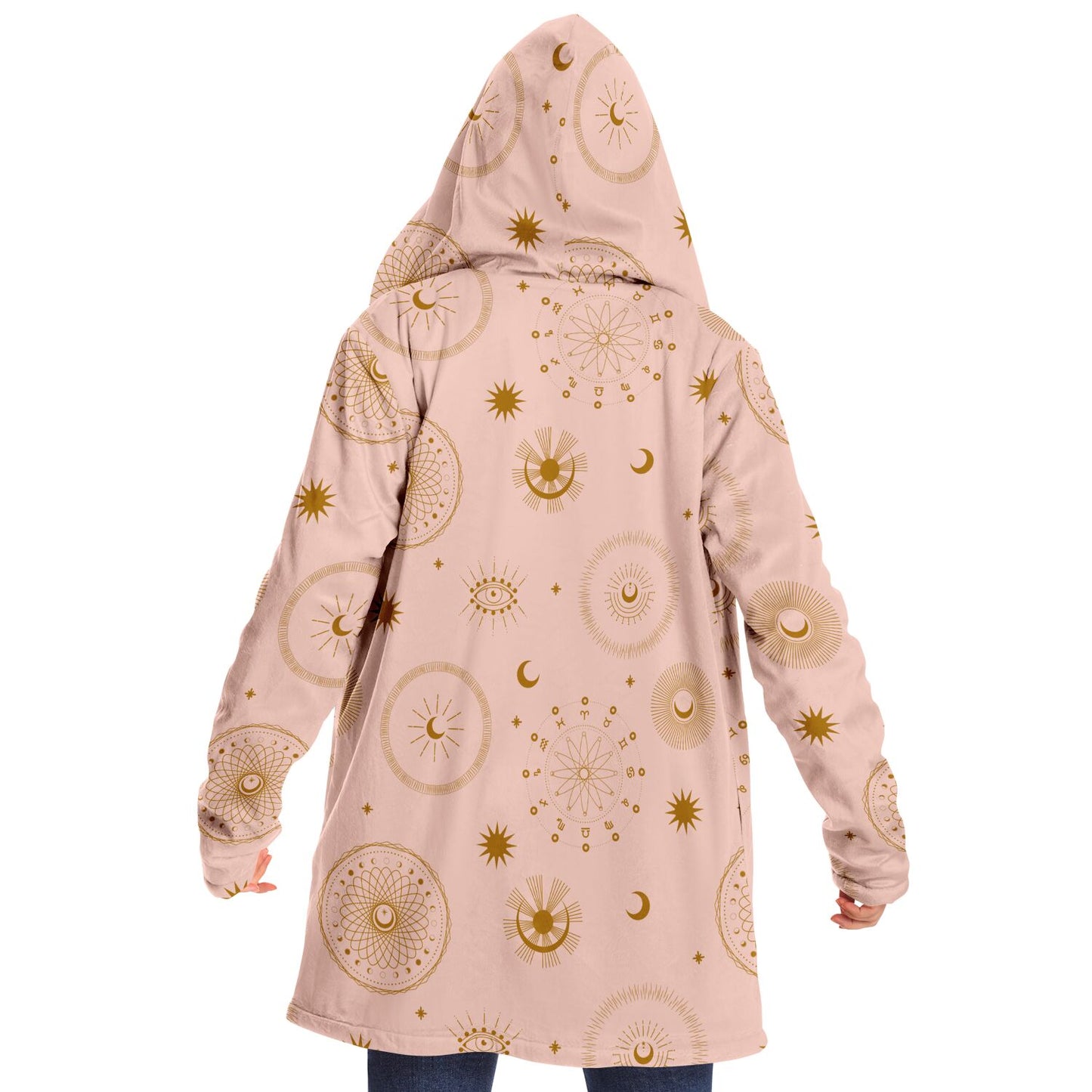 Woman wearing a cozy, hooded, light pink microfleece cloak with gold cosmic zodiac design
