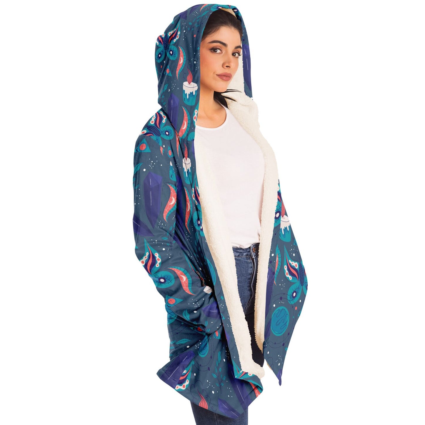 Woman wearing a cozy, hooded, blue microfleece cloak with a colorful butterfly and candle design
