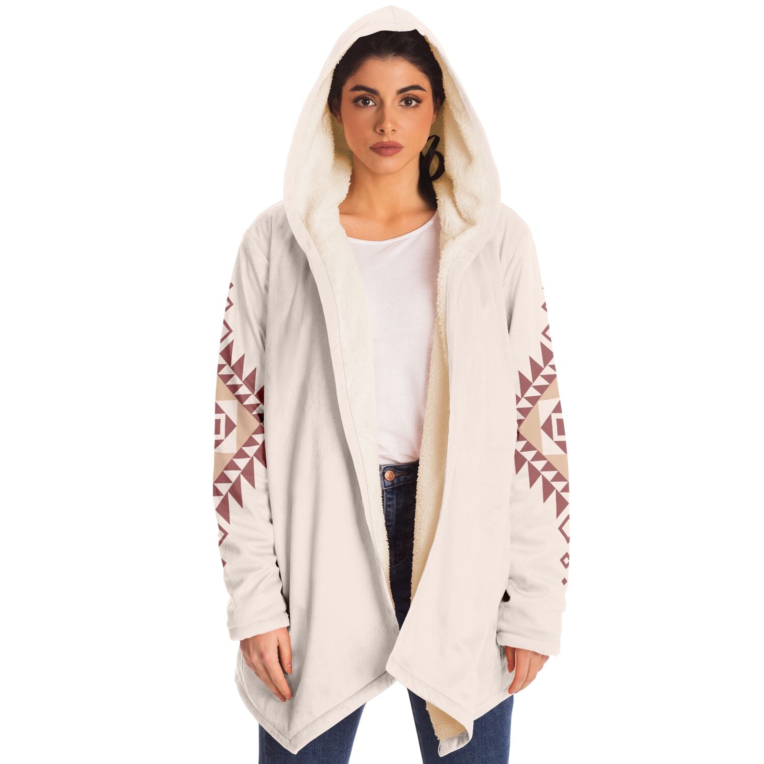 Woman wearing a cozy, hooded, beige microfleece cloak with a pink and tan Southwestern diamond shaped design on the back and elbows.