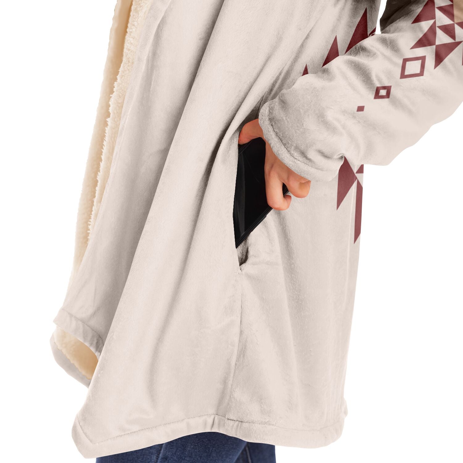 Woman putting a cell phone in the deep pocket of a cozy beige microfleece hoodie.
