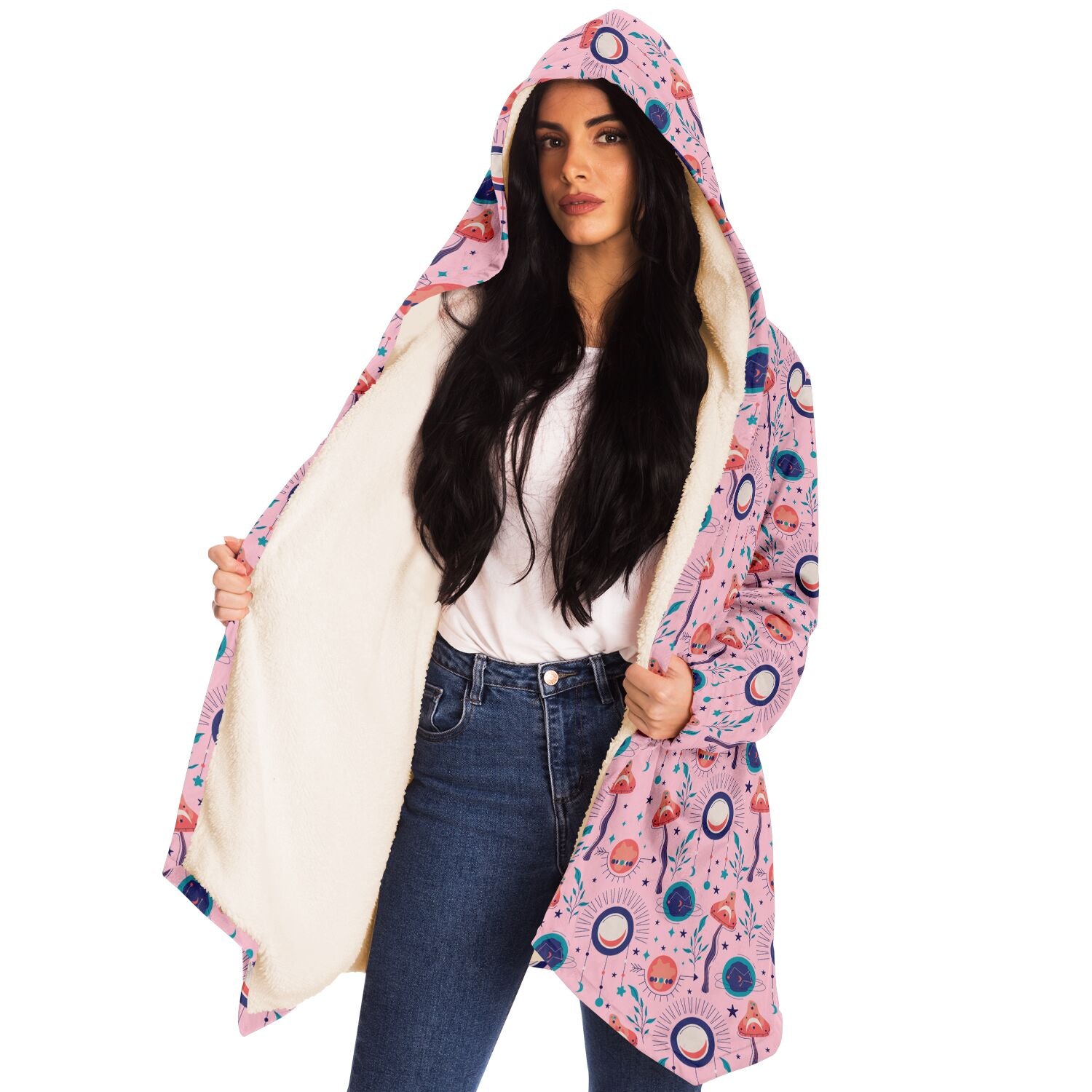 Woman wearing a cozy, hooded, pink microfleece cloak with a colorful, trippy mushroom design.