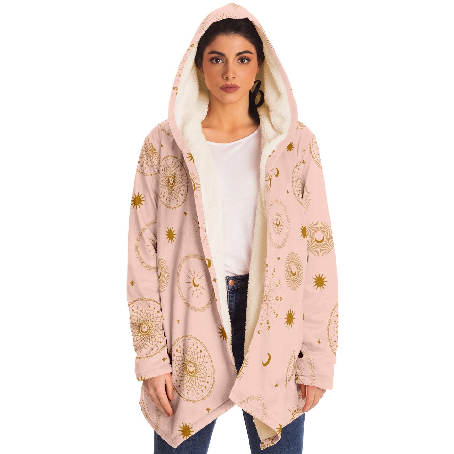 Woman wearing a cozy, hooded, light pink microfleece cloak with gold cosmic zodiac design