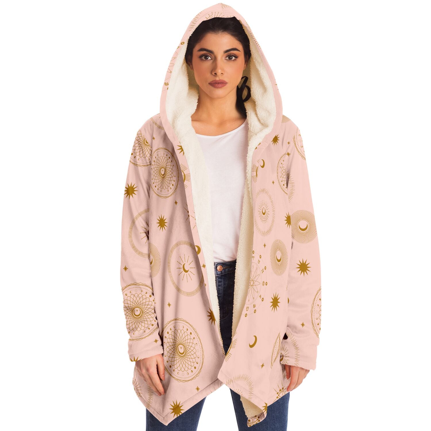 Woman wearing a cozy, hooded, light pink microfleece cloak with gold cosmic zodiac design