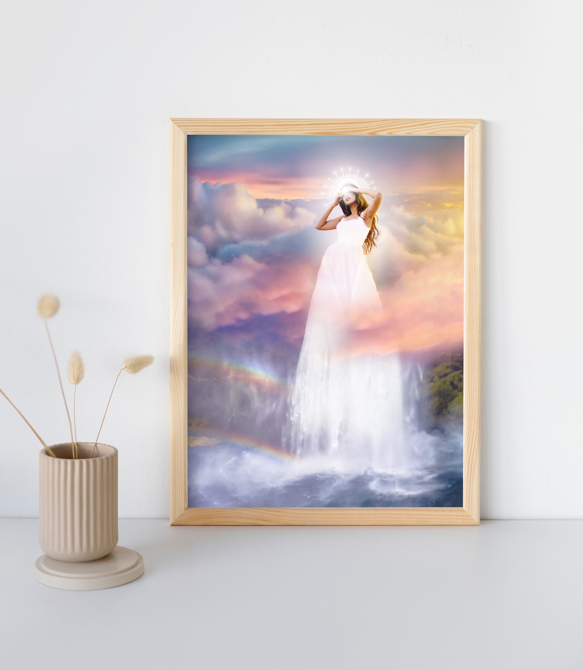 Woman in a white dress standing on a waterfall with a colorful sky and rainbow in the background.