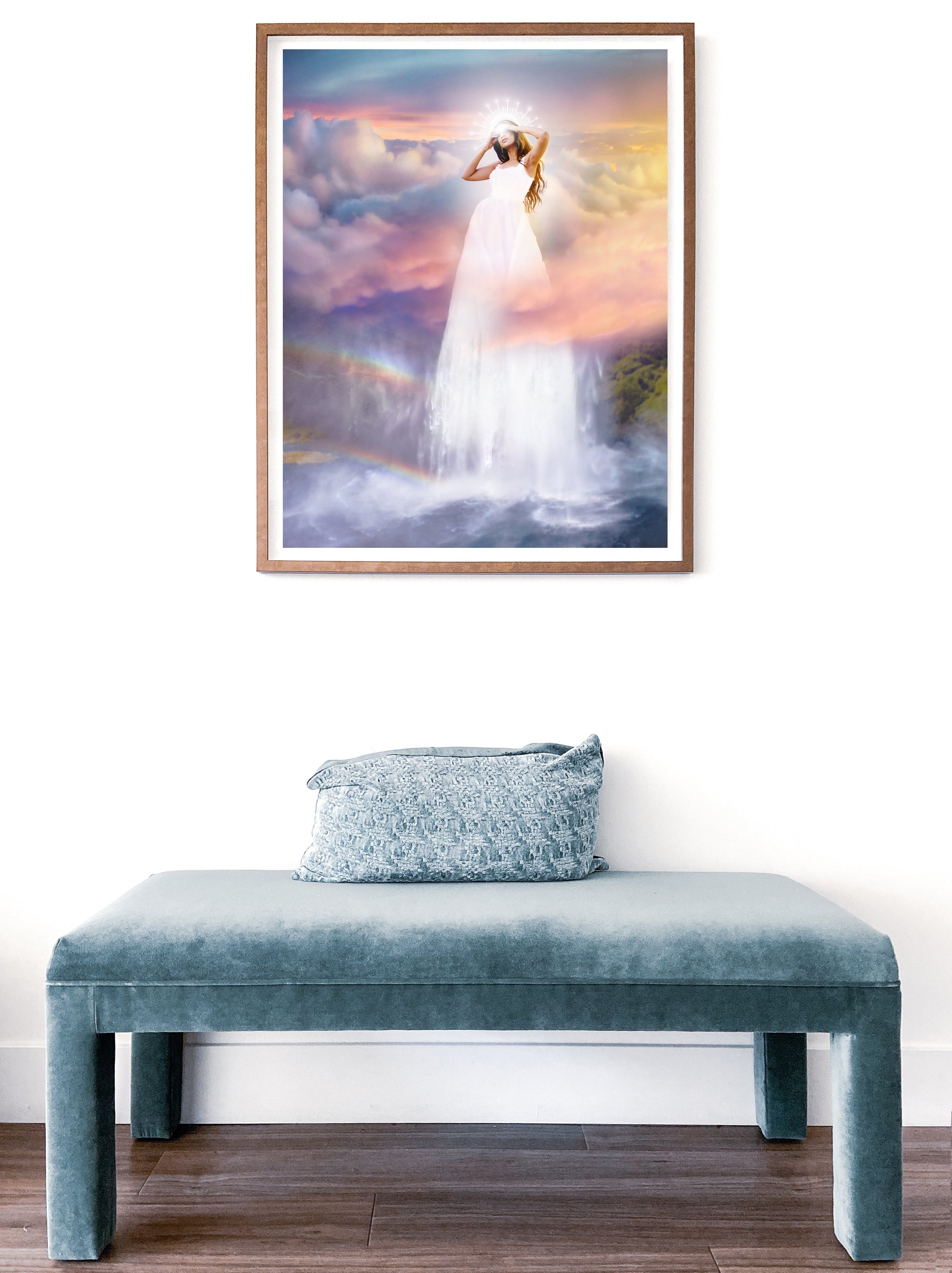 Woman in a white dress standing on a waterfall with a colorful sky and rainbow in the background.