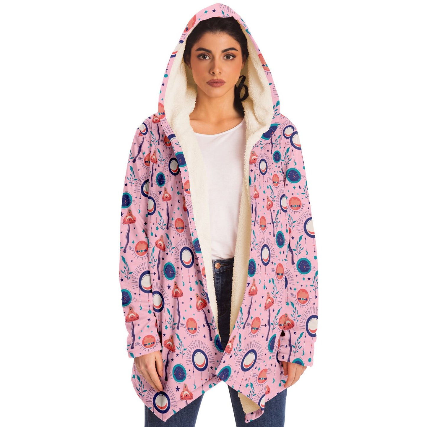 Woman wearing a cozy, hooded, pink microfleece cloak with a colorful, trippy mushroom design.