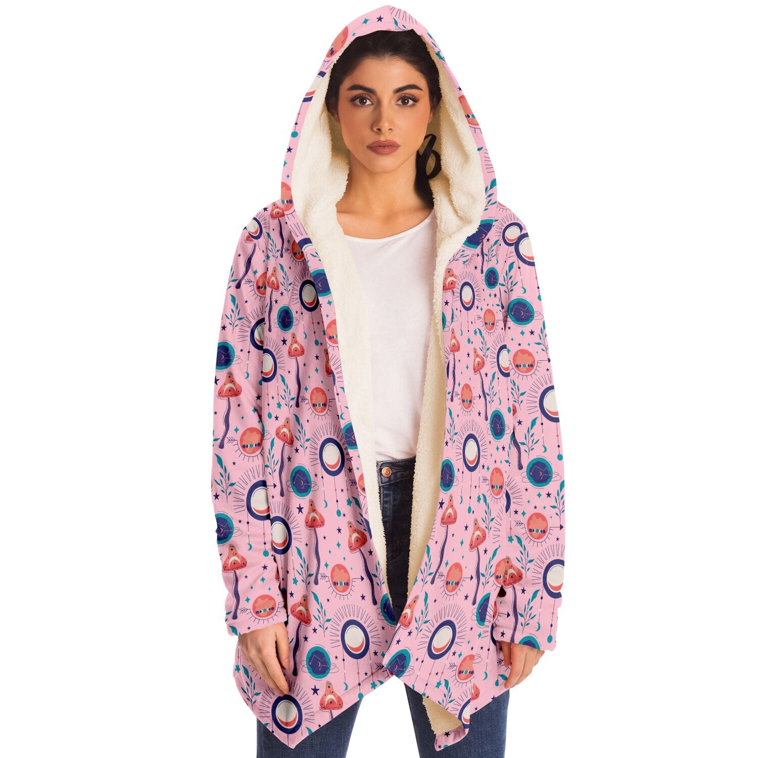 Woman wearing a cozy, hooded, pink microfleece cloak with a colorful, trippy mushroom design.