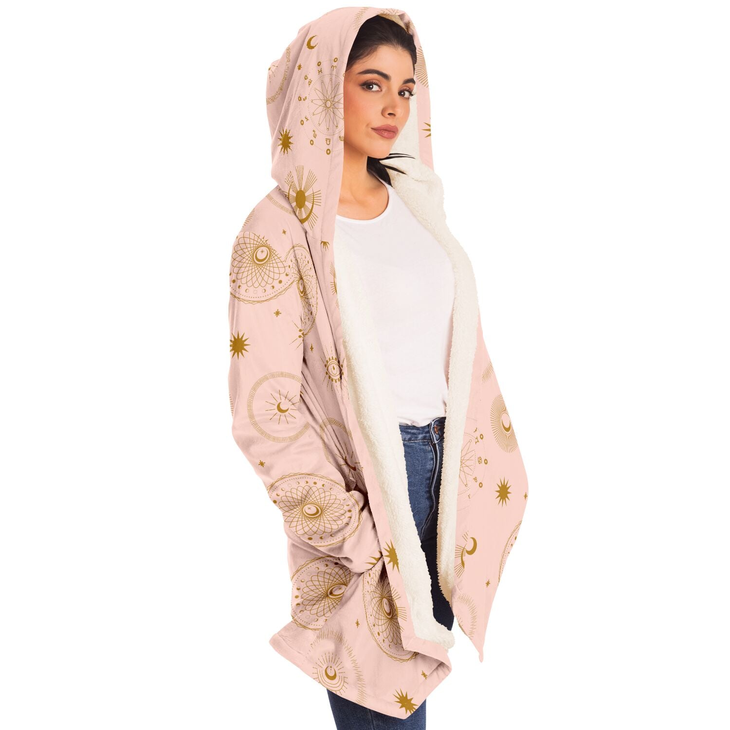 Woman wearing a cozy, hooded, light pink microfleece cloak with gold cosmic zodiac design
