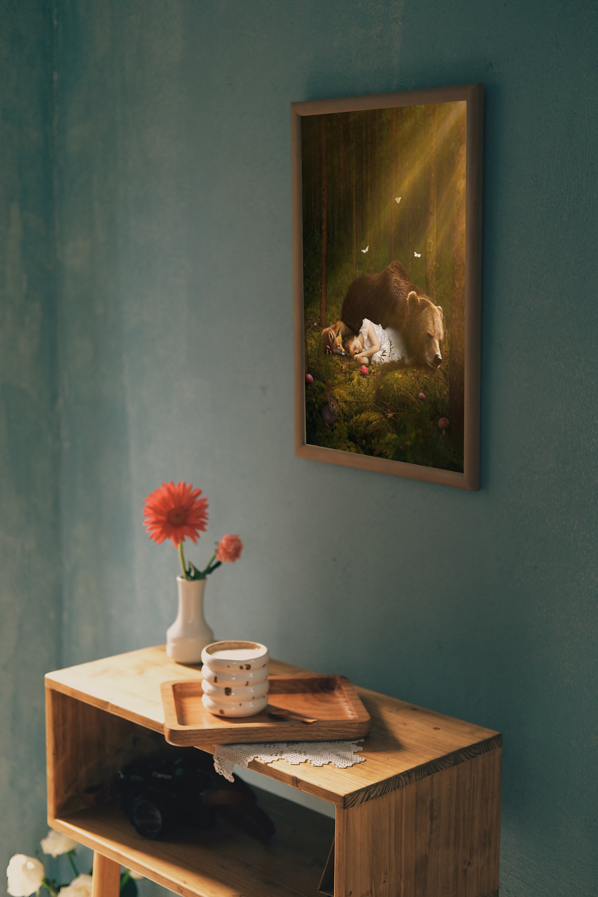 A magical scene of a young girl sleeping on the forest floor with a bear and a fox.