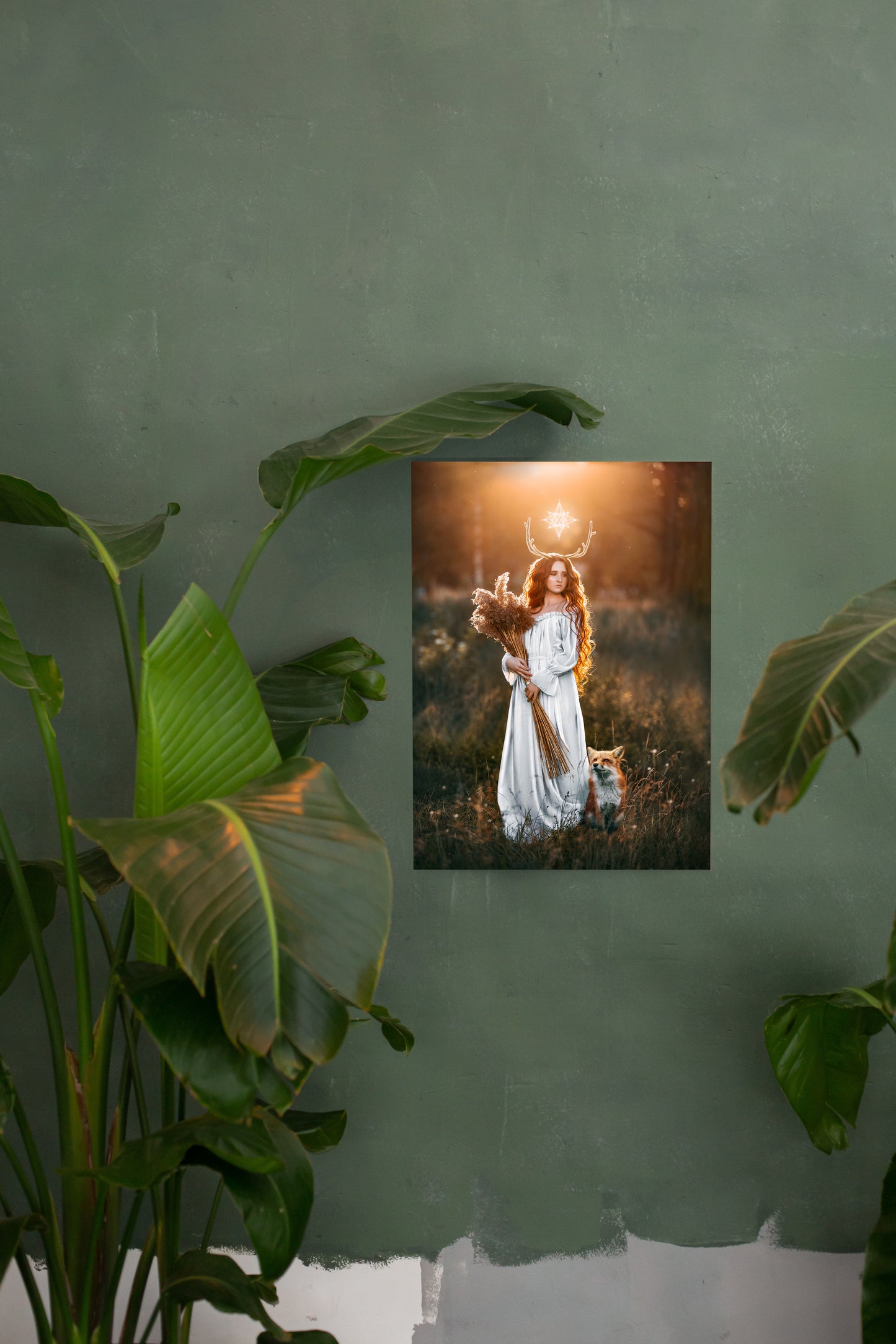 Woman in a white dress with a fox in a field at sunset.