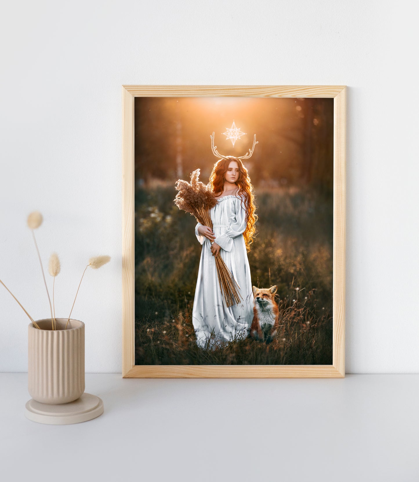 Woman in a white dress with a fox in a field at sunset.