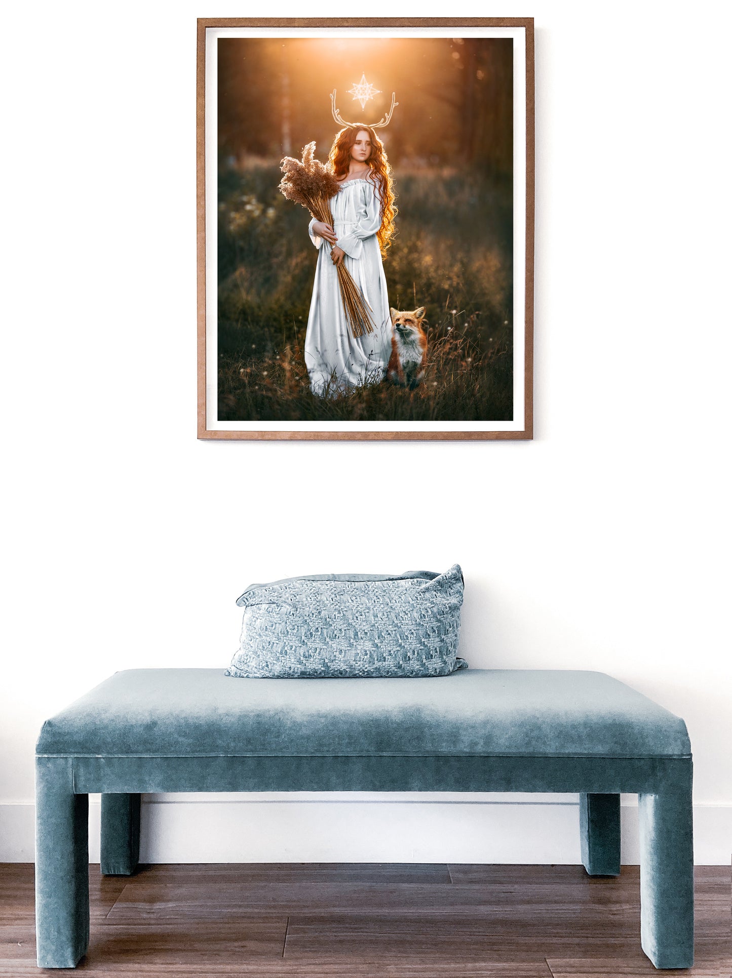 Woman in a white dress with a fox in a field at sunset.