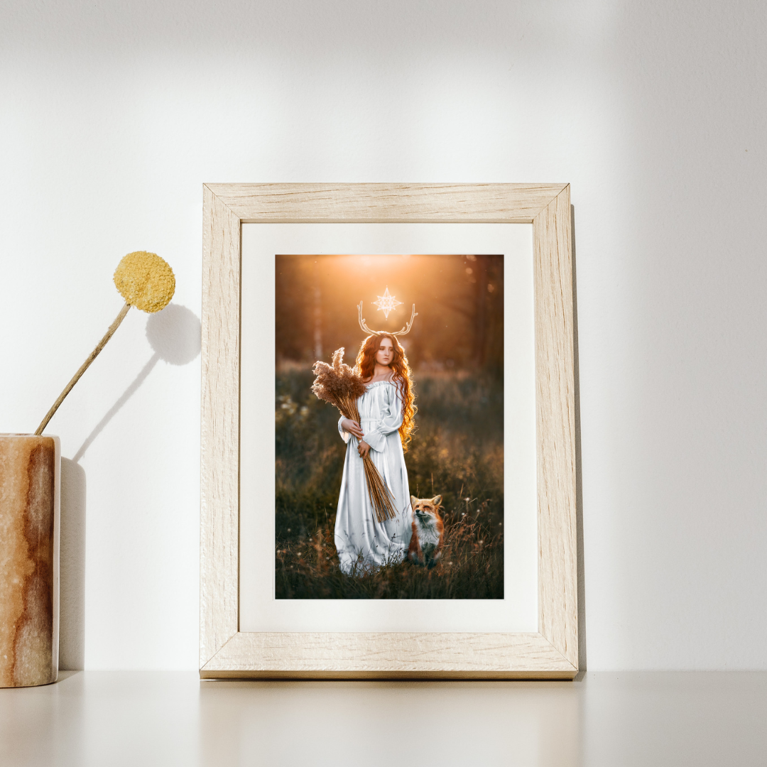 Woman in a white dress with a fox in a field at sunset.