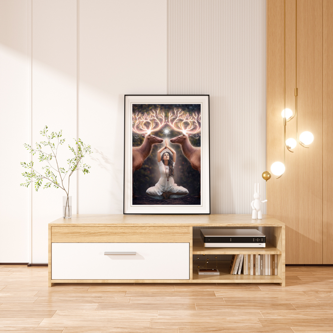 Two elk with glowing antlers stand on either side of a woman meditating in the forest.