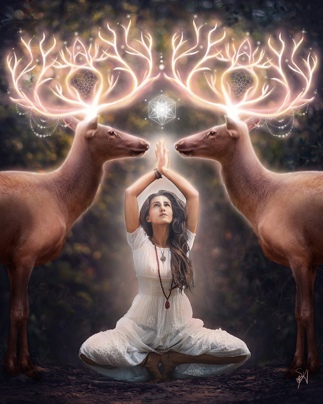 Two elk with glowing antlers stand on either side of a woman meditating in the forest.
