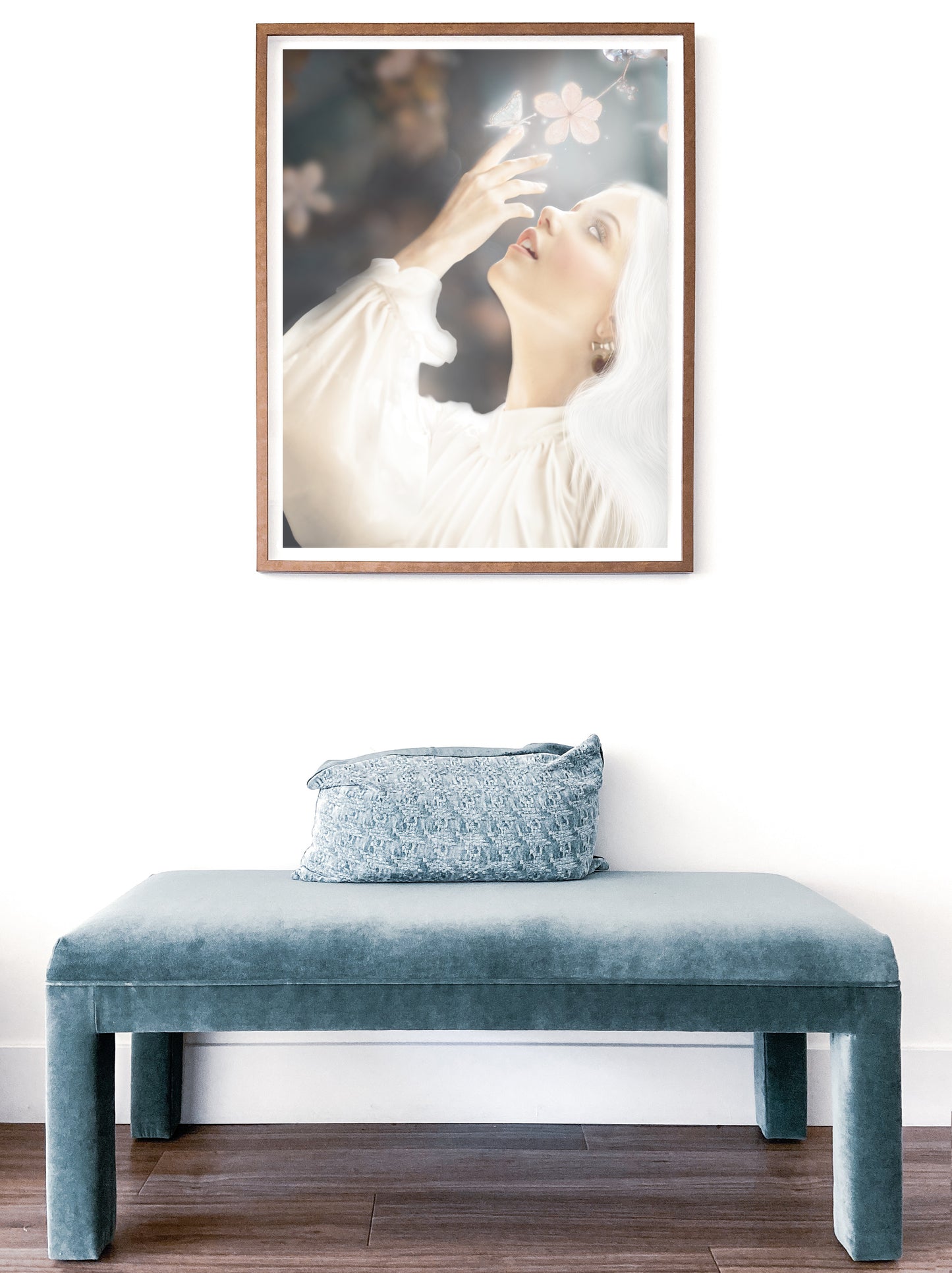 Woman in white reaching towards flowers with a glowing butterfly on her finger.