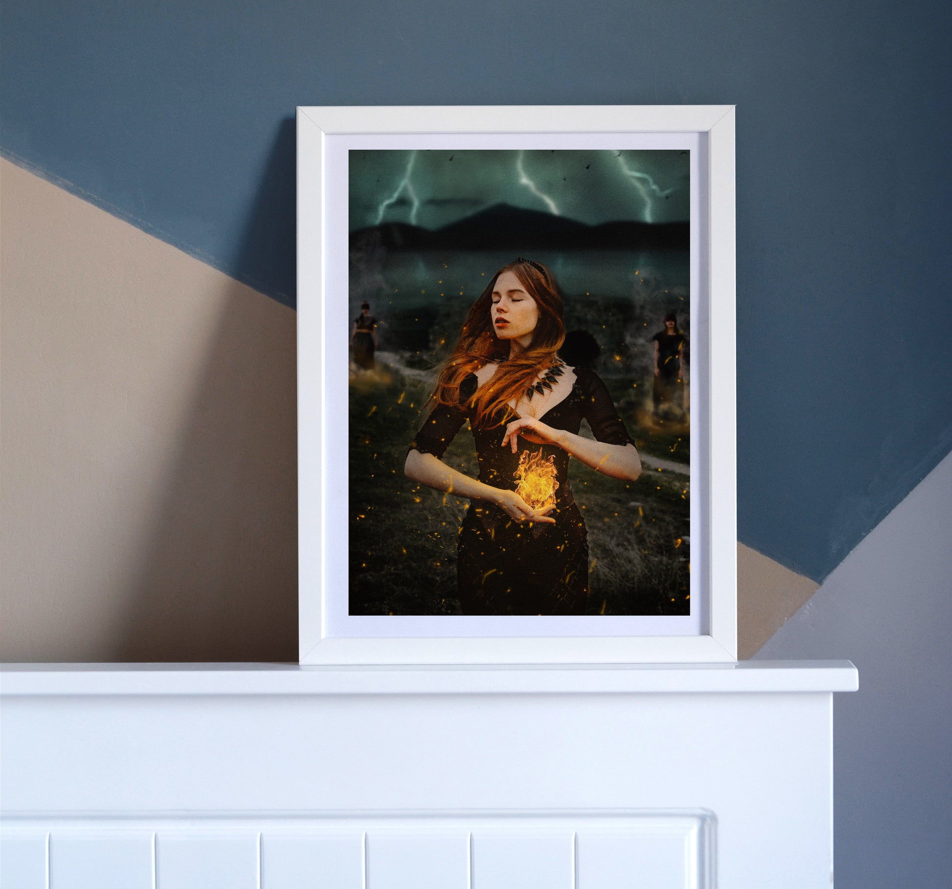 Woman holding a burning flame in her hands with a storm brewing behind her and two women burned at the stake in the background.